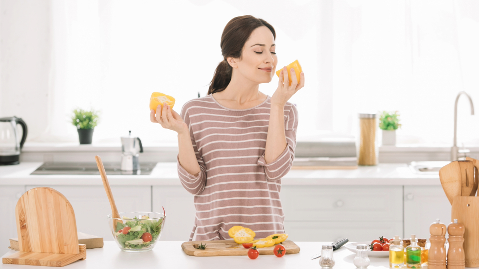 lady smelling bell pepper