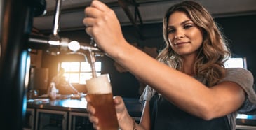 Bartender filling a glass with beer. 